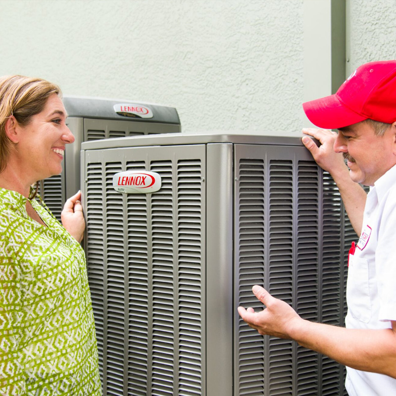 Lennox Employee speaking with woman about Lennox A/C Maintenance